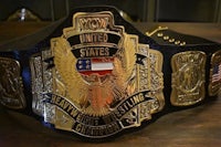 the wwe united states championship belt on a wooden table