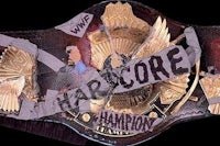 a wwe championship belt with the words hardcore on it